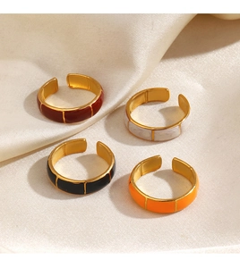 Detail of colorful enamel gold rings with bamboo texture on elegant beige silk fabric