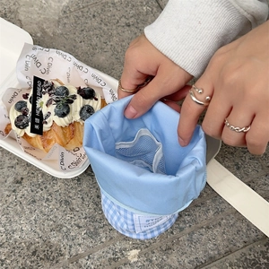 Detail of light blue checkered pencil case showing inner mesh pocket and storage compartments