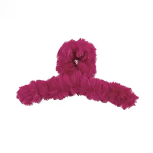Close-up of soft magenta plush faux fur texture on a large claw hair clip for women