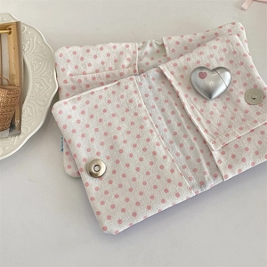 Internal multi-layer compartments of pink polka dot fabric passport holder with metal clasp