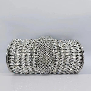 Close-up of sparkling crystals and silver metal hollow frame on the luxury evening clutch