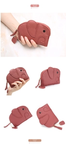 Detail view of leather elephant coin purses in brick red and lobster pink with heart charms
