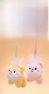 Close-up of soft plush pony pendants in pink and yellow with embroidered facial features