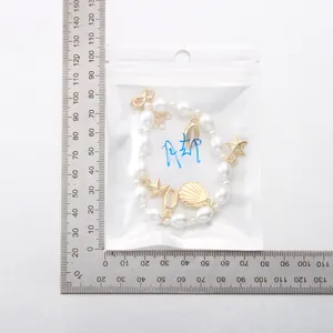 Bohemian pearl anklet with gold starfish and seashell charms measured on a scale