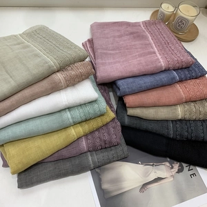 Assorted colors of lightweight cotton linen scarves with delicate lace edge trim details