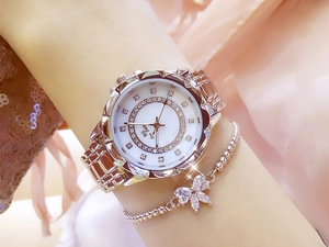 Close-up of elegant rose gold women's watch with crystal floral bracelet on wrist