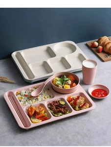 Pink multi-grid wheat straw dinnerware set with matching bowl, cup, and cutlery on a table