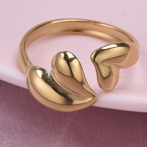 Macro detail of golden open heart ring with mirror polished finish on silk background