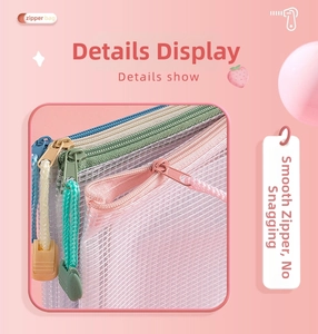 Detail of a smooth metal zipper with nylon puller on a pink mesh storage bag