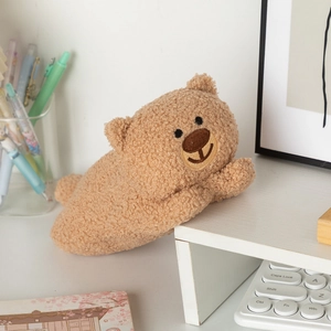 Macro shot of fluffy brown teddy fleece bear stationery bag used as desk decor