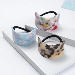 Minimalist acetate geometric hair ties in tortoiseshell and blue floral patterns