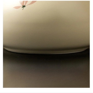 Close-up of the polished flat base of a beige ceramic teapot to prevent surface scratches