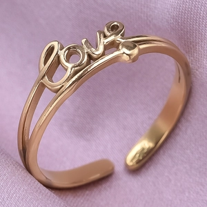 Macro shot of rose gold stainless steel ring featuring an integrated LOVE letter design