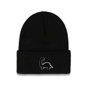 Close-up of black knit beanie featuring white dinosaur embroidery and ribbed texture