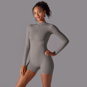 Detailed front view of a dark grey long sleeve fitness romper with zipper neckline