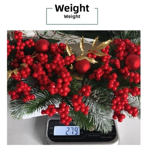 Detailed weight measurement of Christmas red berry wreath with snow frosted pine needles