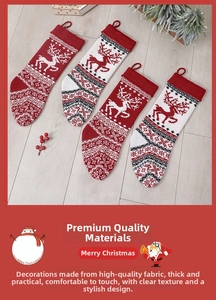 Macro detail of knit Christmas stockings with reindeer patterns on wood floor background