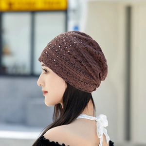 Detail of brown lace slouchy beanie featuring sparkling rhinestone and pearl embellishments