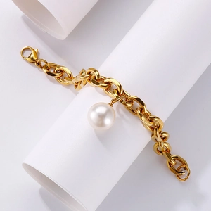 Golden titanium steel thick chain bracelet with a large white shell pearl on a white stand