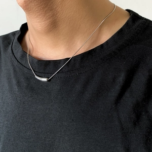 Men's silver metal necklace with curved tube pendant on minimalist chain streetwear style