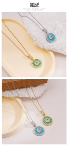 Detailed close-up of 18K gold and silver starburst pendants with turquoise and zircons