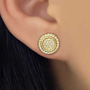 Macro close-up of gold double hoop earrings with pave-set zircon stones on an ear