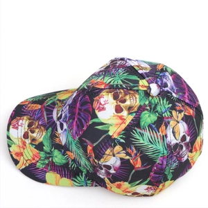 Detailed top view of a baseball cap with tropical leaf and skull prints on fabric