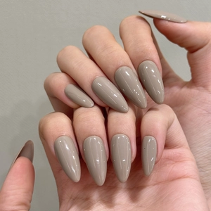 Close-up of elegant mocha grey almond-shaped press-on nails with a high-gloss mirror finish