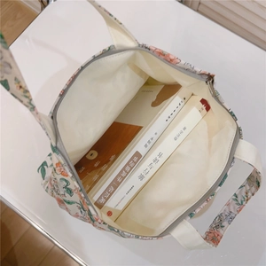 Detail showing the spacious interior of floral cotton tote bag with gray zipper closure