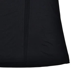Macro shot of the side slit and high-quality textured black fabric on the elegant dress