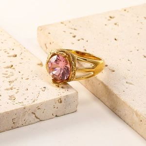 Macro shot of 18K gold plated ring with large faceted pink zircon on stone blocks