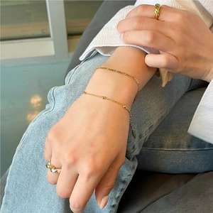 Minimalist S925 sterling silver beaded bracelet and gold ring set shown on a model