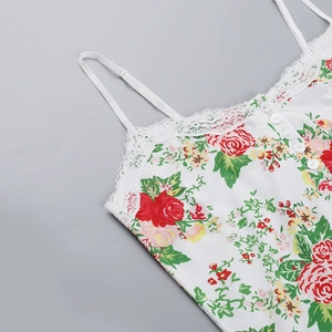 Close-up of floral camisole featuring red rose print, lace trim, and delicate buttons