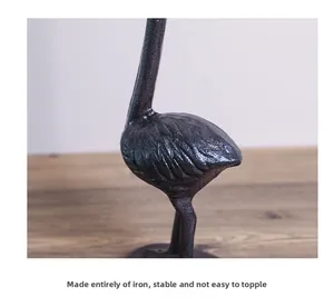 Detail of the cast iron flamingo tissue holder featuring a stable matte black iron base
