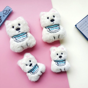 Plush Westie puppy toys with blue Little Baby bibs on a decorative pink background