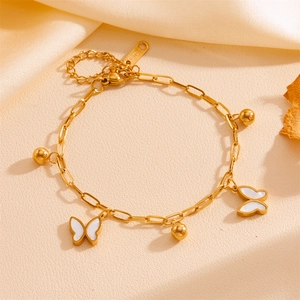 Detail of gold stainless steel bracelet with white butterfly charms and lobster clasp