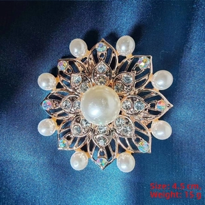 Detail of rose gold sunflower brooch with pearls and crystals on blue silk background