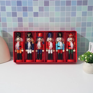 Set of six wooden Christmas nutcracker soldiers in a red gift box for tree decoration