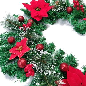 Close-up of artificial 2.7m Christmas garland with red poinsettias and festive pine needles