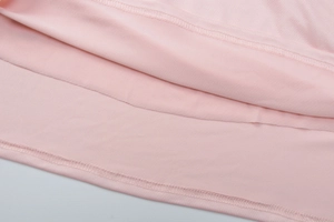 Close-up of high-quality double stitching and texture on the pink dress hemline