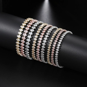 Three-color marquise cz tennis bracelets in gold, silver, and rose gold on black display