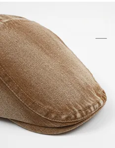 Close-up of wide-brim brown washed cotton cap featuring vintage twill texture details