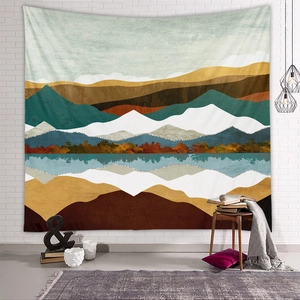 Detailed texture of an abstract mountain tapestry hanging on a white brick wall for home decor