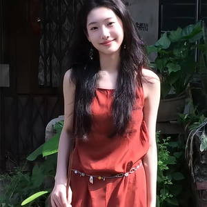 Ethnic style red sleeveless dress featuring a metallic waist chain with beaded pendants