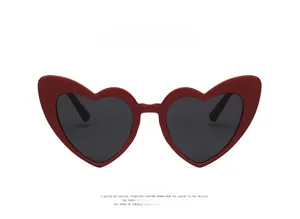 Front view of heart-shaped sunglasses in russet red frame with dark gray lenses