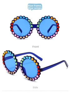 Detail view of round blue children's sunglasses with colorful rainbow rhinestones