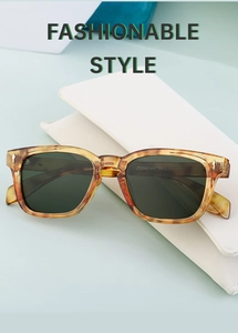 Detail of amber tortoiseshell polarized sunglasses resting on white case