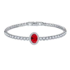 Detail of red oval gemstone surrounded by small diamonds on a silver tennis bracelet