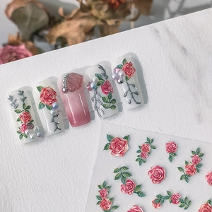 5D embossed nail art stickers featuring red roses and green leaves on white marble background