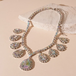 Macro detail of pear-shaped AB crystal pendant necklace with sparkling silver setting